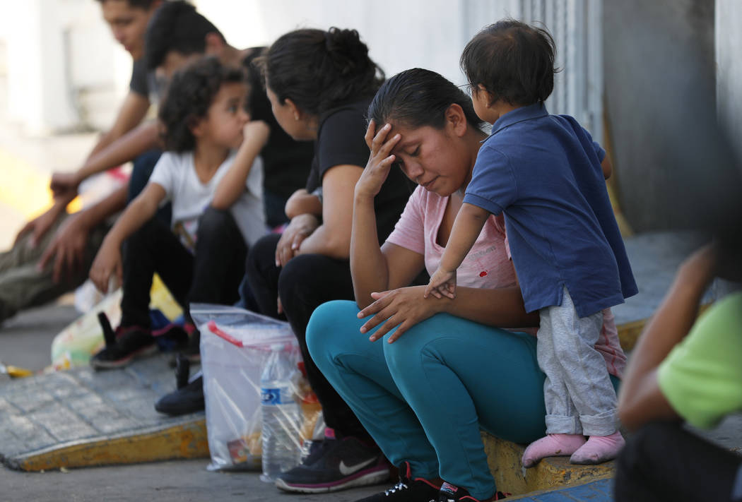 Migrants wait at an immigration center on the International Bridge 1, in Nuevo Laredo, Mexico, ...