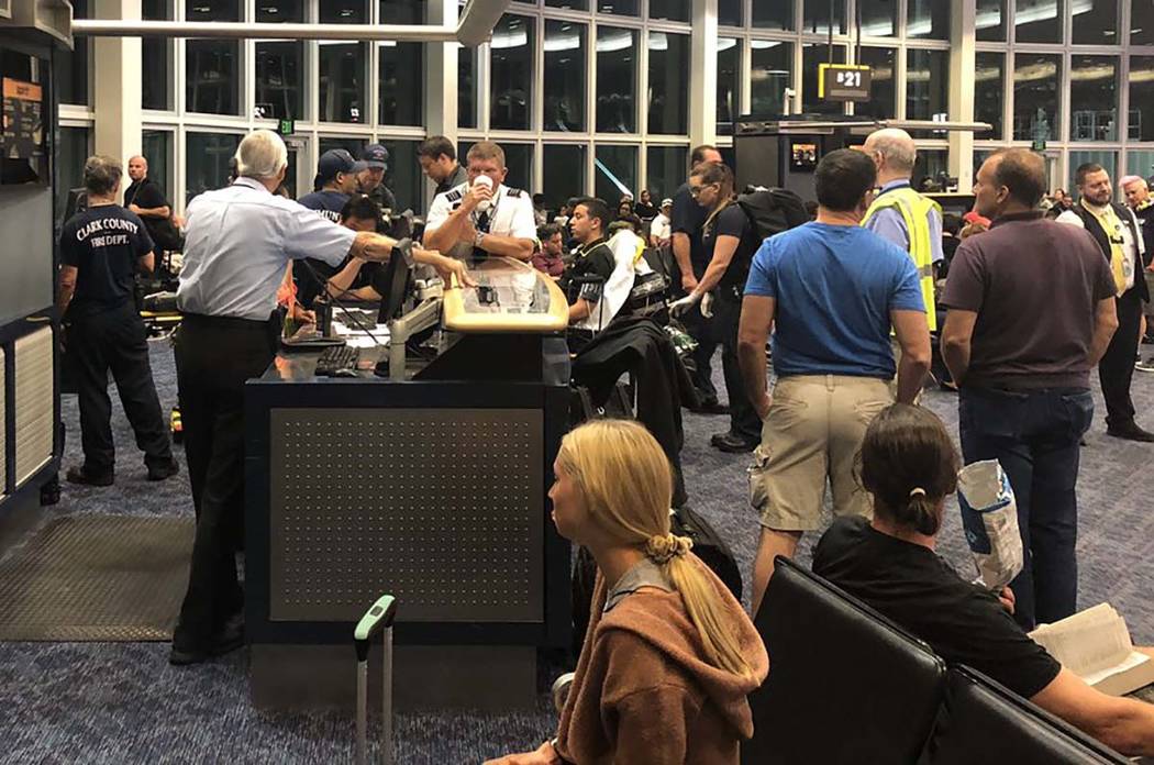 Clark County Fire Department crews respond to Terminal 1 to aid six people who complained of fu ...