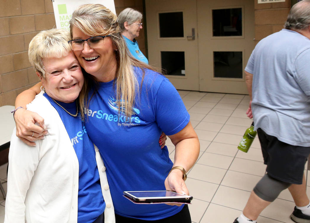 Anita Stephens, right, a SilverSneakers fitness instructor, greets Ellen Garland, 68, before cl ...