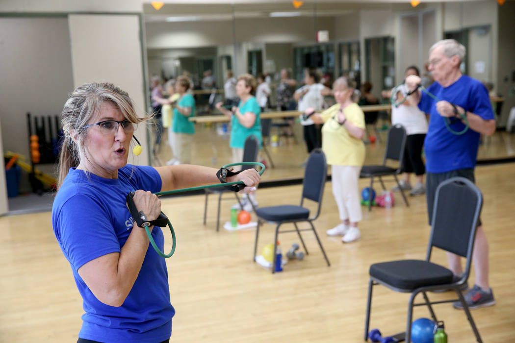 Anita Stephens teaches a Body Flow class as part of the SilverSneakers fitness program at Duran ...