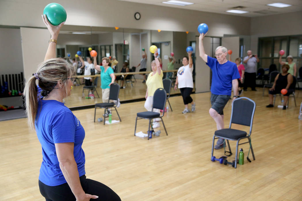 Anita Stephens teaches a Body Flow class as part of the SilverSneakers fitness program at Duran ...