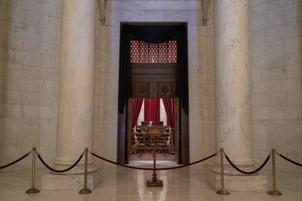 The doors to the Supreme Court are draped in black in honor of retired Associate Justice John P ...