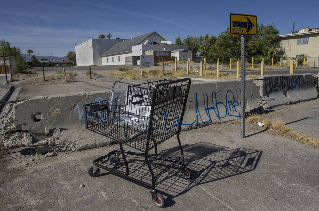 An abandoned shopping cart filled with trash at the intersection of West Warren Drive and North ...