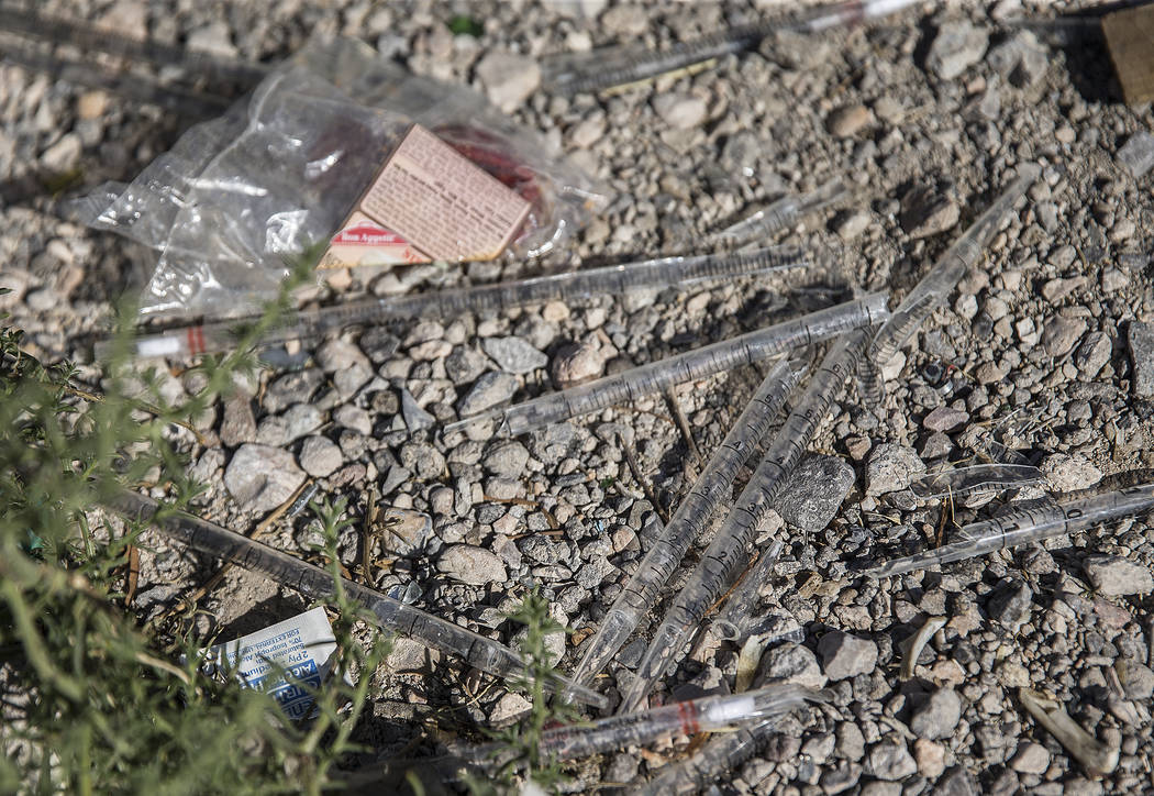 Unused syringes are mixed in with other trash near the intersection of West Charleston Boulevar ...
