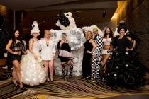 Attendees show off their outfits during Aid for AIDS of Nevada's (AFAN) 30th annual Black & Whi ...