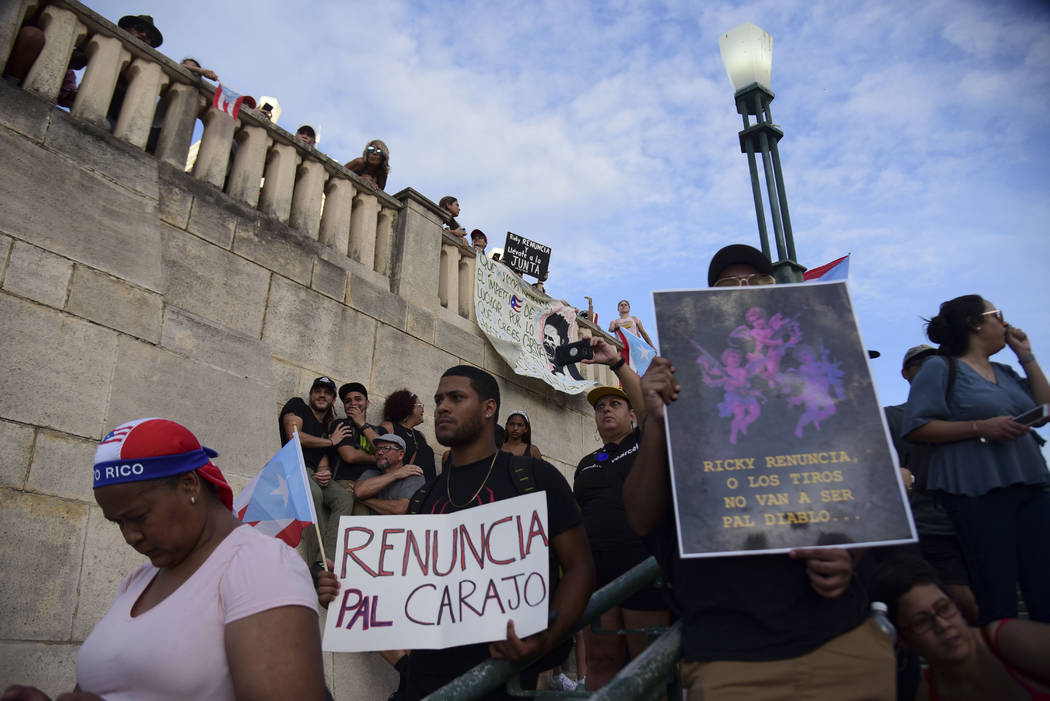 Citizens gather at the Quinto Centenario Plaza to protest against governor Ricardo Rossello, in ...