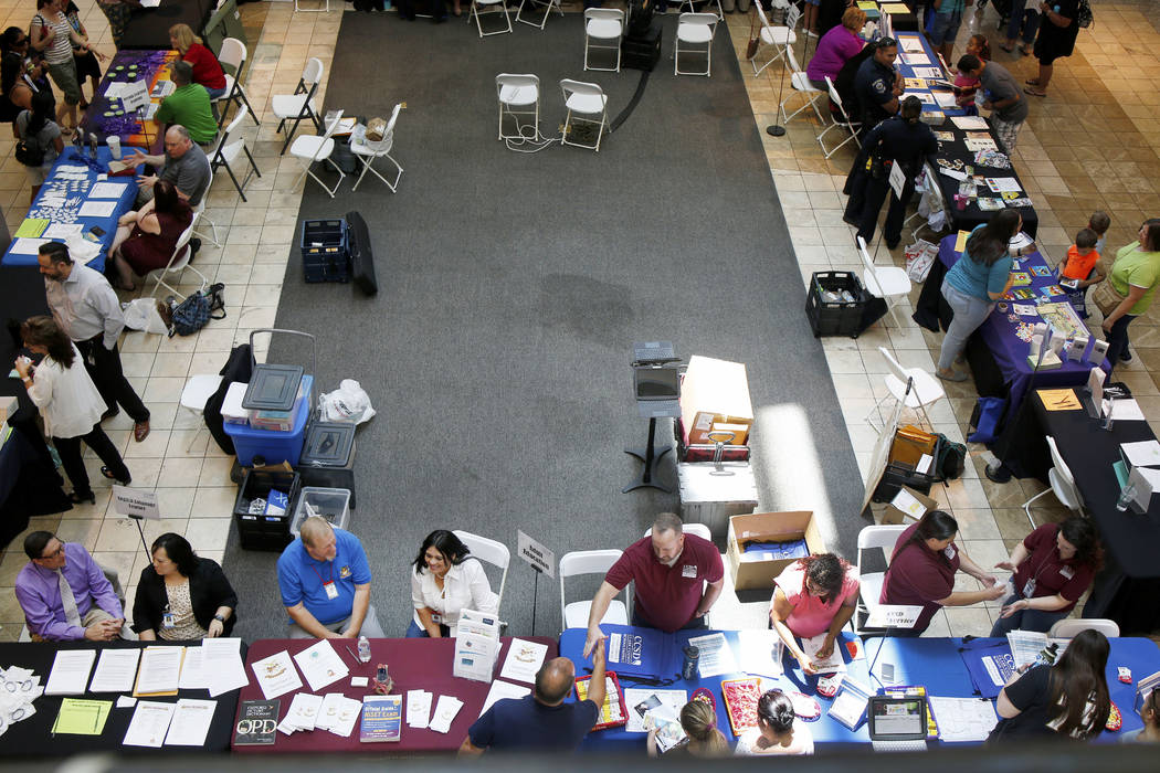 Individuals visit booths during the annual Cox Back to School Fair at the Galleria at Sunset ma ...