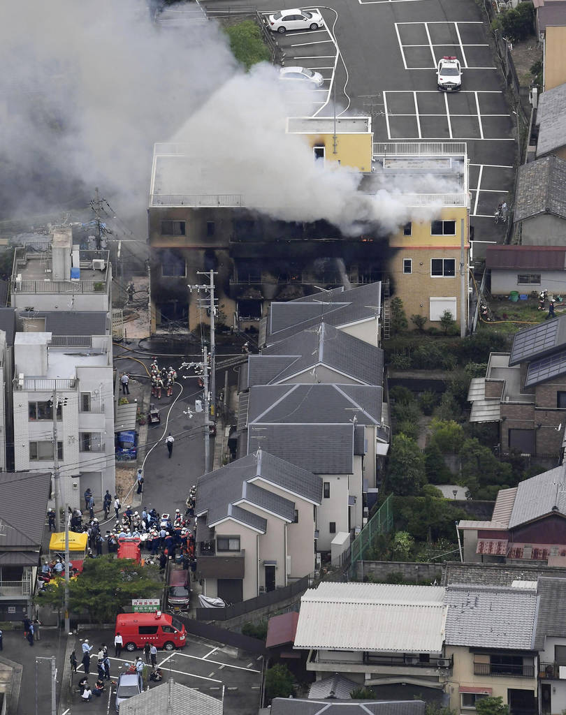 Smoke billows from a three-story building of Kyoto Animation in a fire in Kyoto, western Japan, ...
