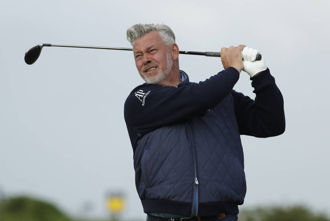 Northern Ireland's Darren Clarke tees of the 4th hole during the first round of the British Ope ...