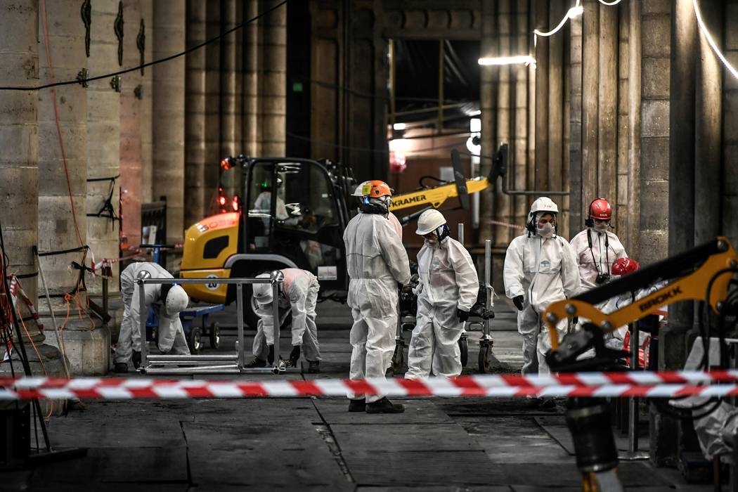 Workers are pictured during preliminary work at the Notre-Dame de Paris Cathedral, Wednesday, J ...