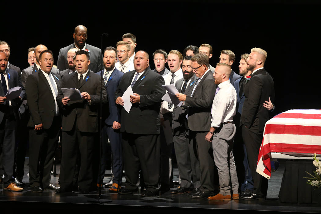 Sons, brothers-in-law and nephews sing "Warriors of Light" during funeral services fo ...