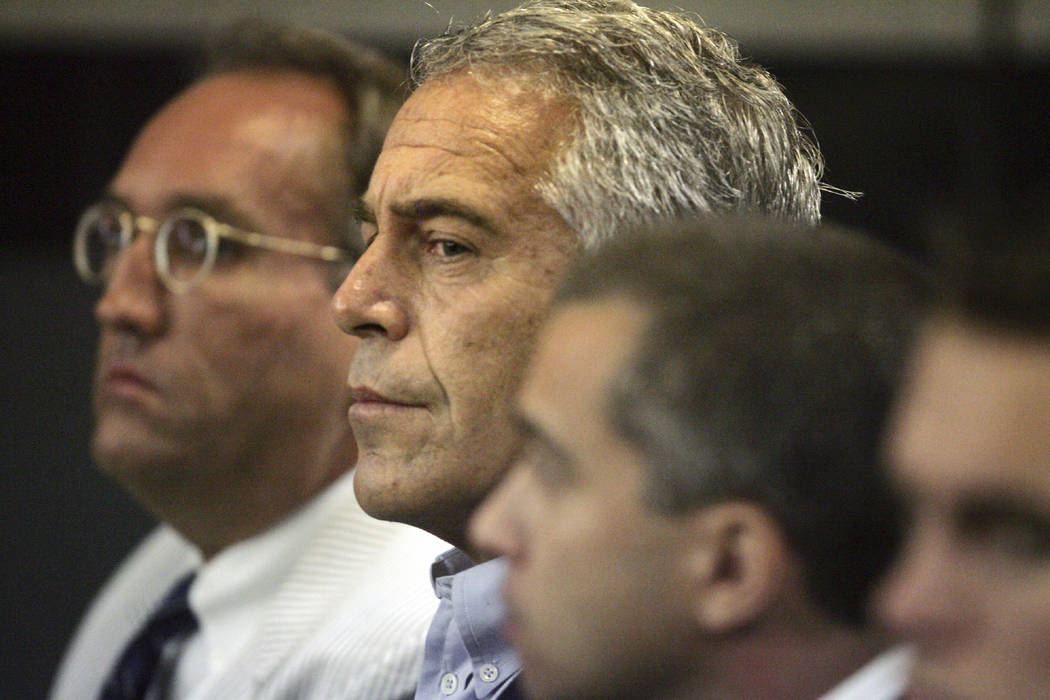 In a July 30, 2008, file photo, Jeffrey Epstein, center, appears in court in West Palm Beach, F ...
