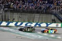 Kurt Busch crosses the finish line ahead of Kyle Busch (18) to win the NASCAR Cup Series auto r ...