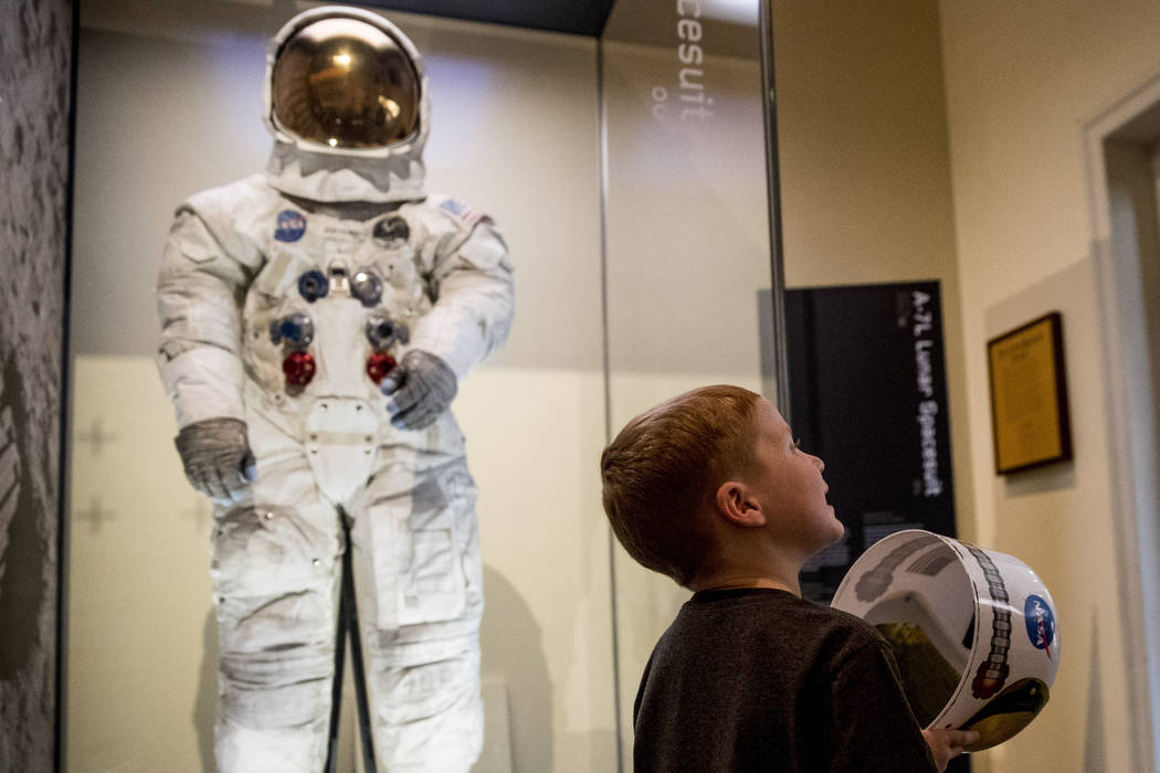 Jack Heely, 5, of Alexandria, Va., plays with a toy space helmet as he arrives as one of the fi ...
