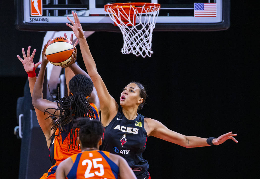 Connecticut Sun forward Jonquel Jones (35) has a shot attempt blocked by Las Vegas Aces center ...