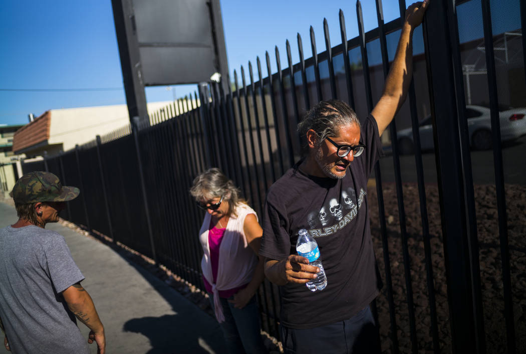 Brian Diaz, right, talks about living homeless while waiting in line for food on Foremaster Lan ...