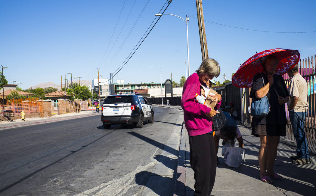 A Las Vegas police car passes by homeless people on Foremaster Lane near downtown Las Vegas on ...