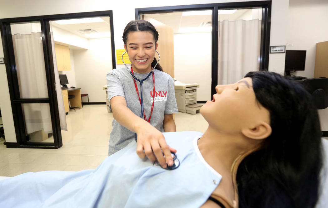Summer camp student Victoria Tarango, 17, practices on a medical doll at Clinical Simulation Ce ...