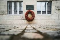 In this Friday, July 12, 2019 photo a wreath fixed under a remembrance plaque marking the place ...