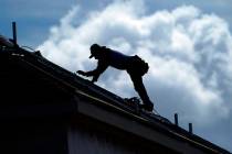 A roofer works on a new home under construction Thursday, July 18, 2019, in Houston. A heat wav ...
