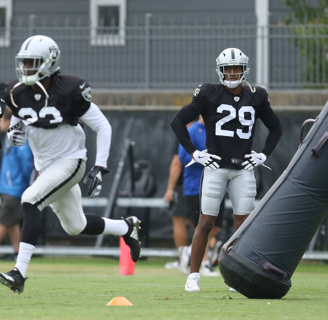 Oakland Raiders defensive back Leon Hall (29) watches cornerback Dexter McDonald (23) run throu ...