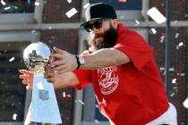New England Patriots' Julian Edelman reaches for a Super Bowl trophy during their victory parad ...