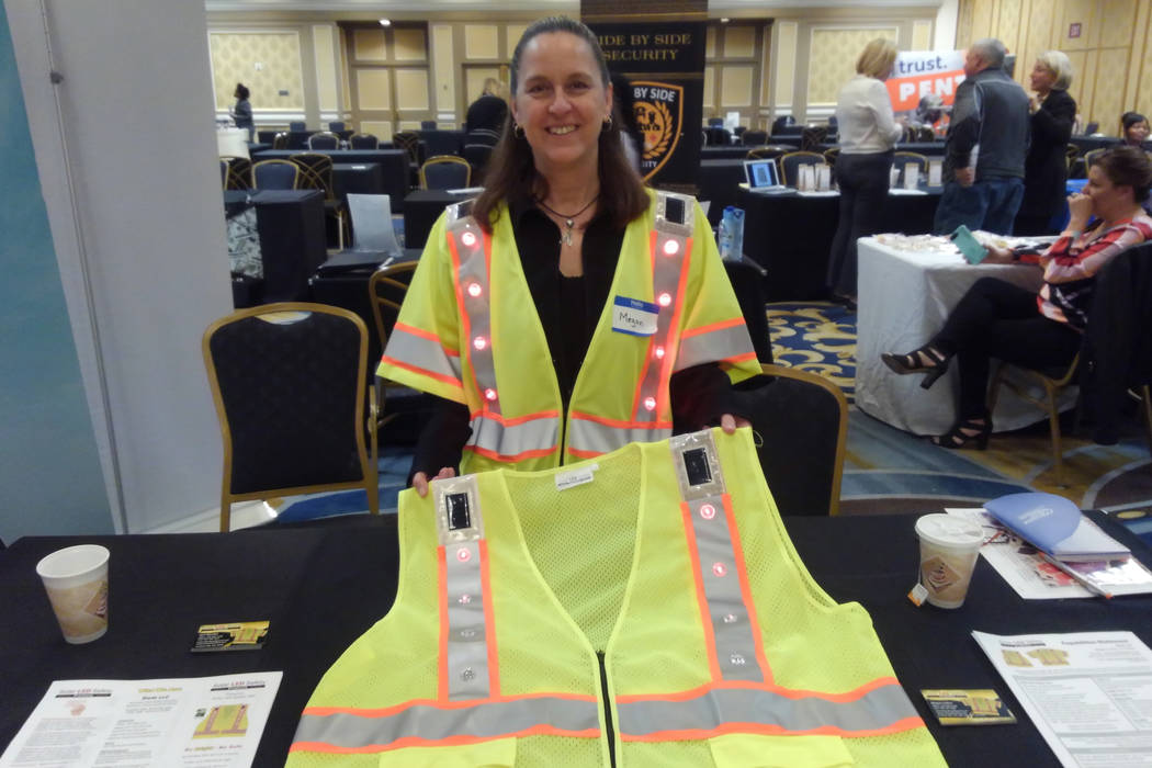 Megan Collins, co-founder of Solar LED Safety Products, is pictured with a safety vest she and ...