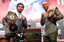 Manny Pacquiao, left, and Keith Thurman pose for pictures during a press conference ahead of th ...