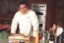 Chef Emeril Lagasse poses on the set of his cooking show in New York April 17, 1998. "Emer ...
