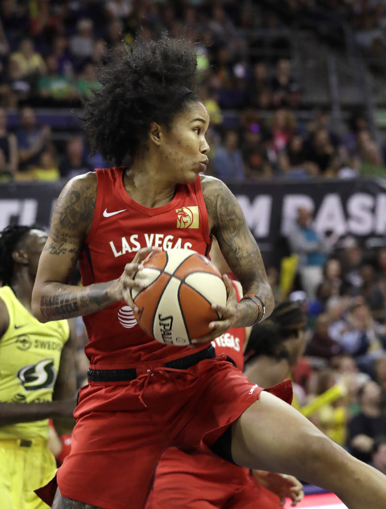 Las Vegas Aces' Tamera Young grabs a rebound against the Seattle Storm during the first half of ...