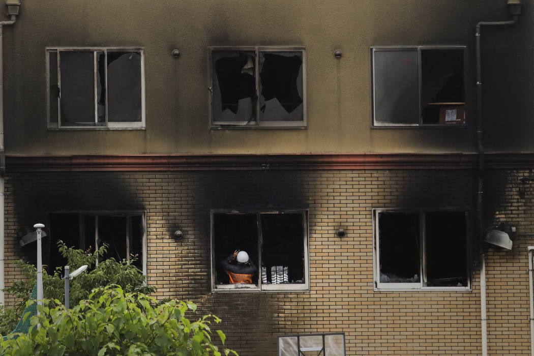 An investigator takes pictures inside the Kyoto Animation Studio building destroyed in an arson ...