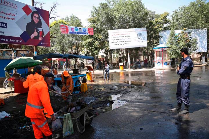 Afghan security forces stand guard near the site of an explosion in Kabul, Afghanistan, Friday, ...