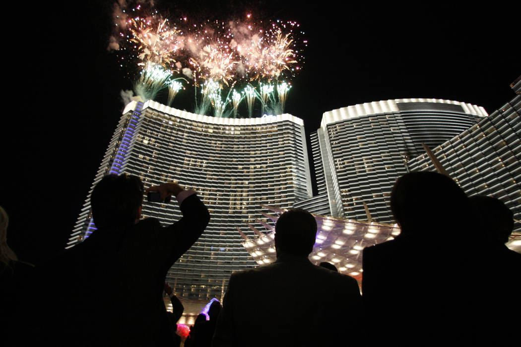 Fireworks explode over the 60-story tower of the Aria hotel-casino at the CityCenter resort com ...