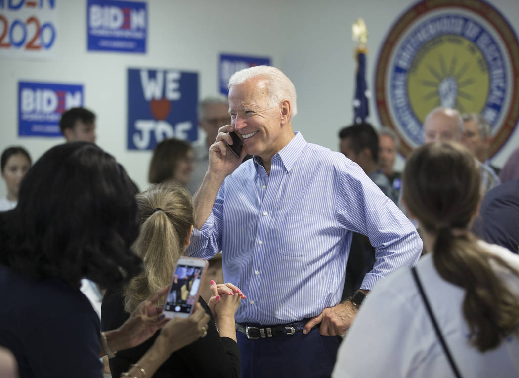 Democratic presidential candidate former Vice President Joe Biden, middle, makes phone calls du ...