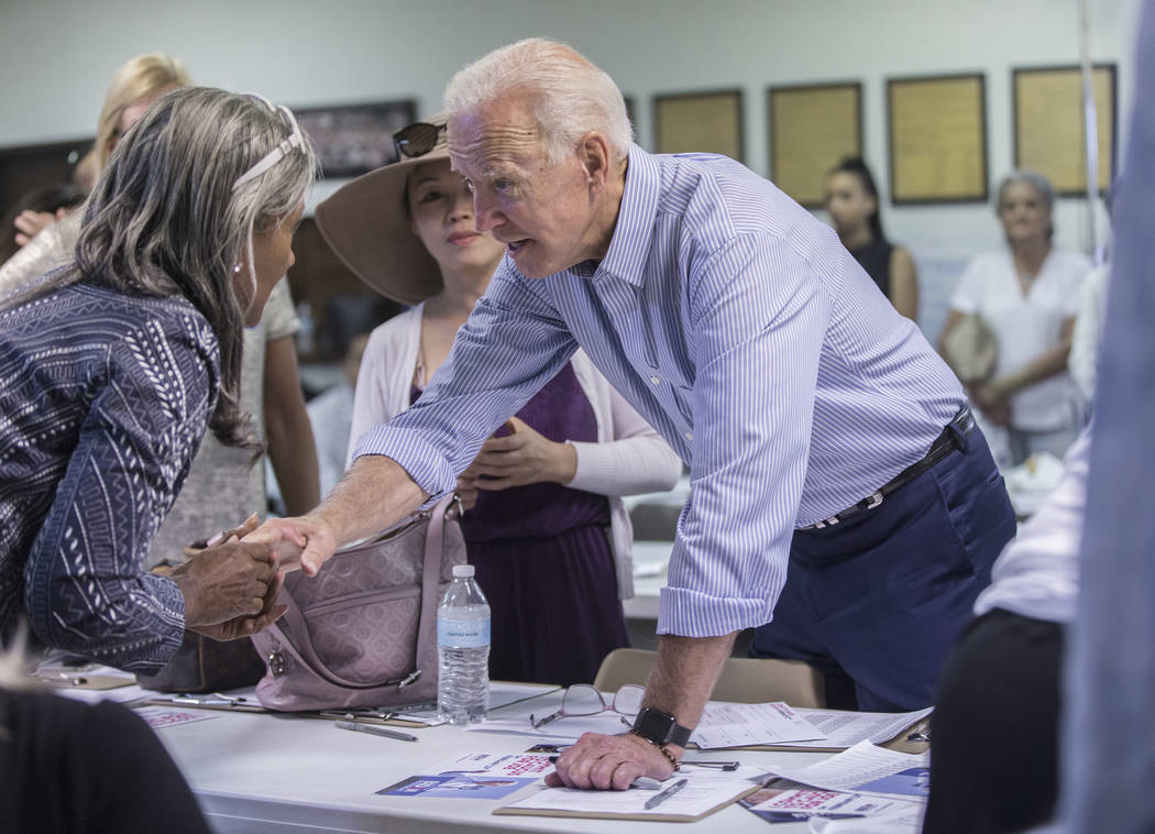 Democratic presidential candidate former Vice President Joe Biden, right, greets volunteer Cynt ...
