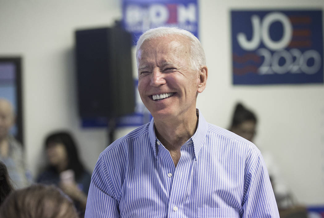 Democratic presidential candidate former Vice President Joe Biden shares a laugh with volunteer ...