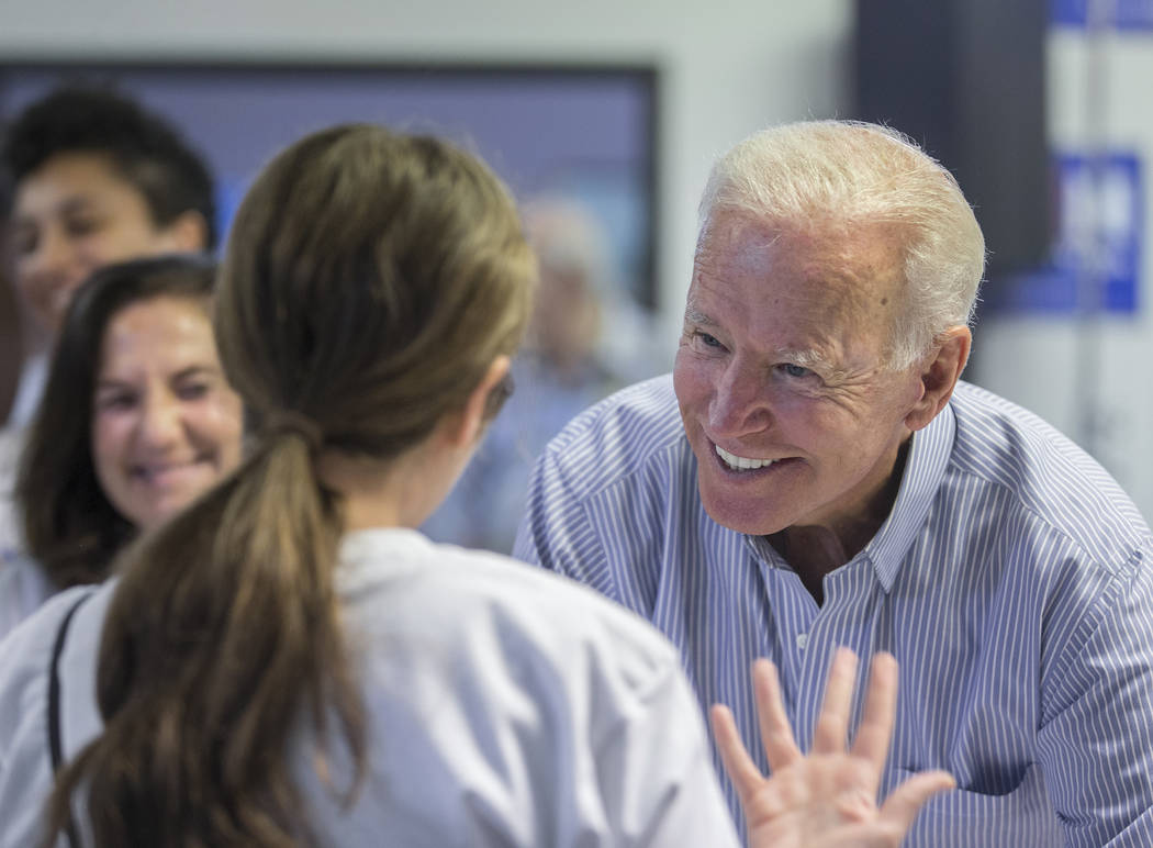 Democratic presidential candidate former Vice President Joe Biden, right, greets volunteers dur ...