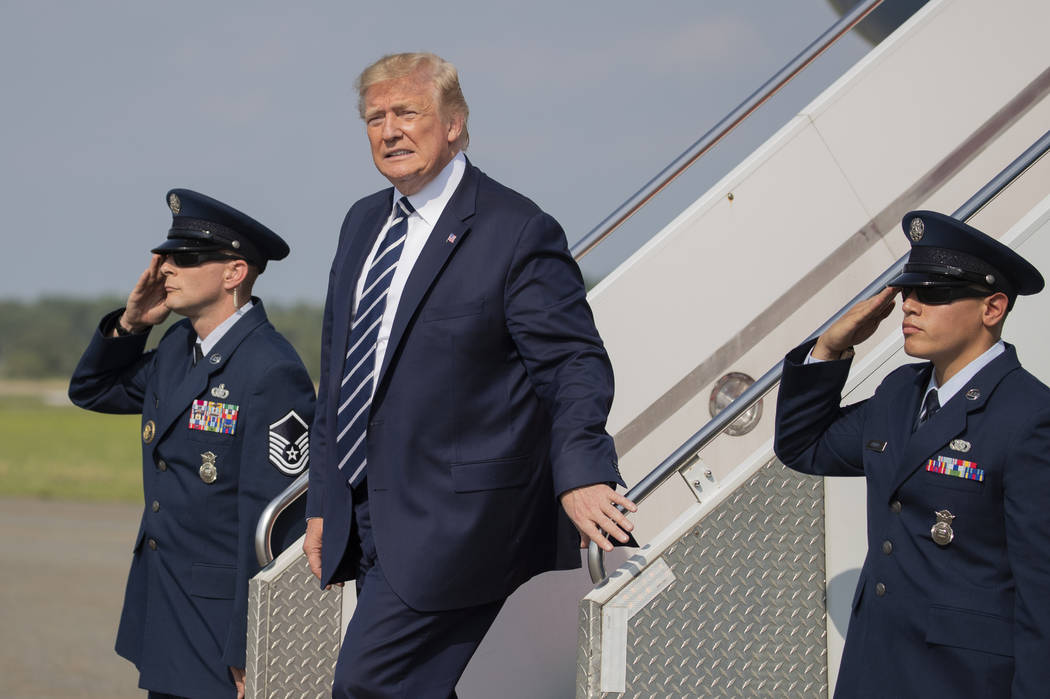 President Donald Trump, disembarks Air Force One upon arrival at Morristown Municipal Airport, ...