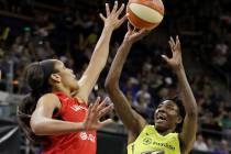Seattle Storm's Natasha Howard, right, shoots as Las Vegas Aces' A'ja Wilson defends during the ...
