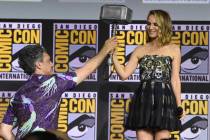Director Taika Waititi hands the Thor hammer to Natalie Portman during the "Thor Love And ...