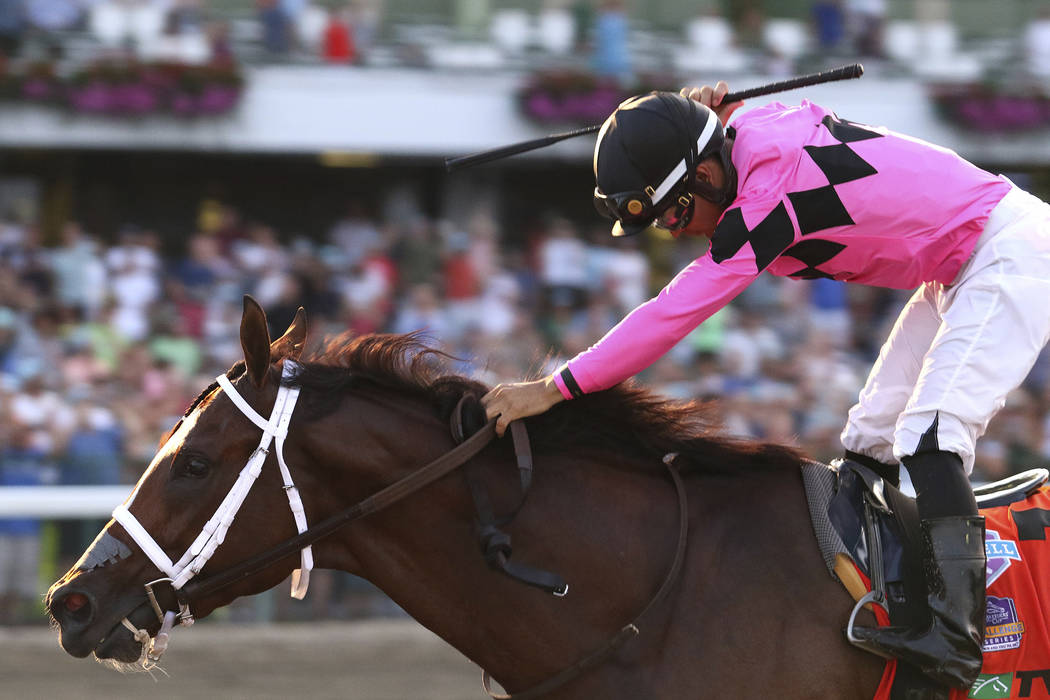 In this image provided by Bill Denver/EQUI-PHOTO, Inc., Luis Saez, top, reacts after guiding Ma ...