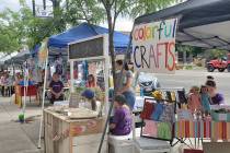 Budding entrepreneurs set up booths on the sidewalk, to sell their products during the Children ...