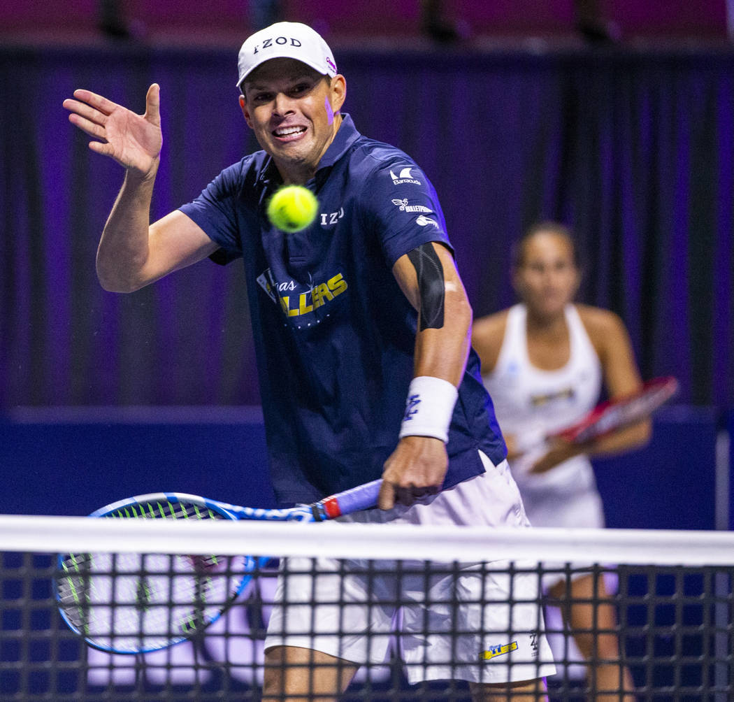 The Vegas Rollers' Bob Bryan returns a ball over the net in front of mixed doubles parter Monic ...