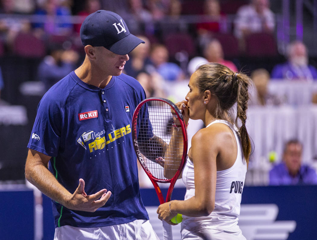 Vegas Rollers head coach Tim Blenkiron confers with Monica Puig in a timeout during her women's ...