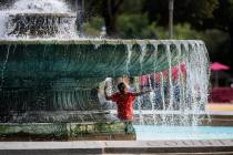 Alex Paladino cools off at the Eakins Oval fountain in Philadelphia on Sunday, July 21, 2019. ( ...