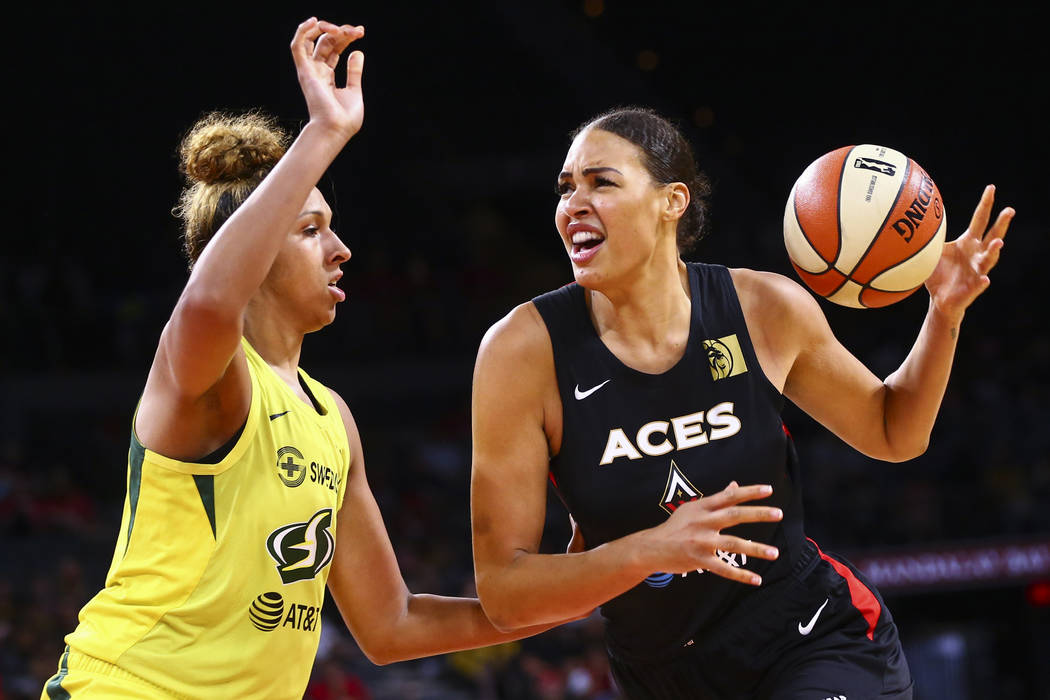 Las Vegas Aces' Liz Cambage moves the ball against Seattle Storm's Mercedes Russell during the ...