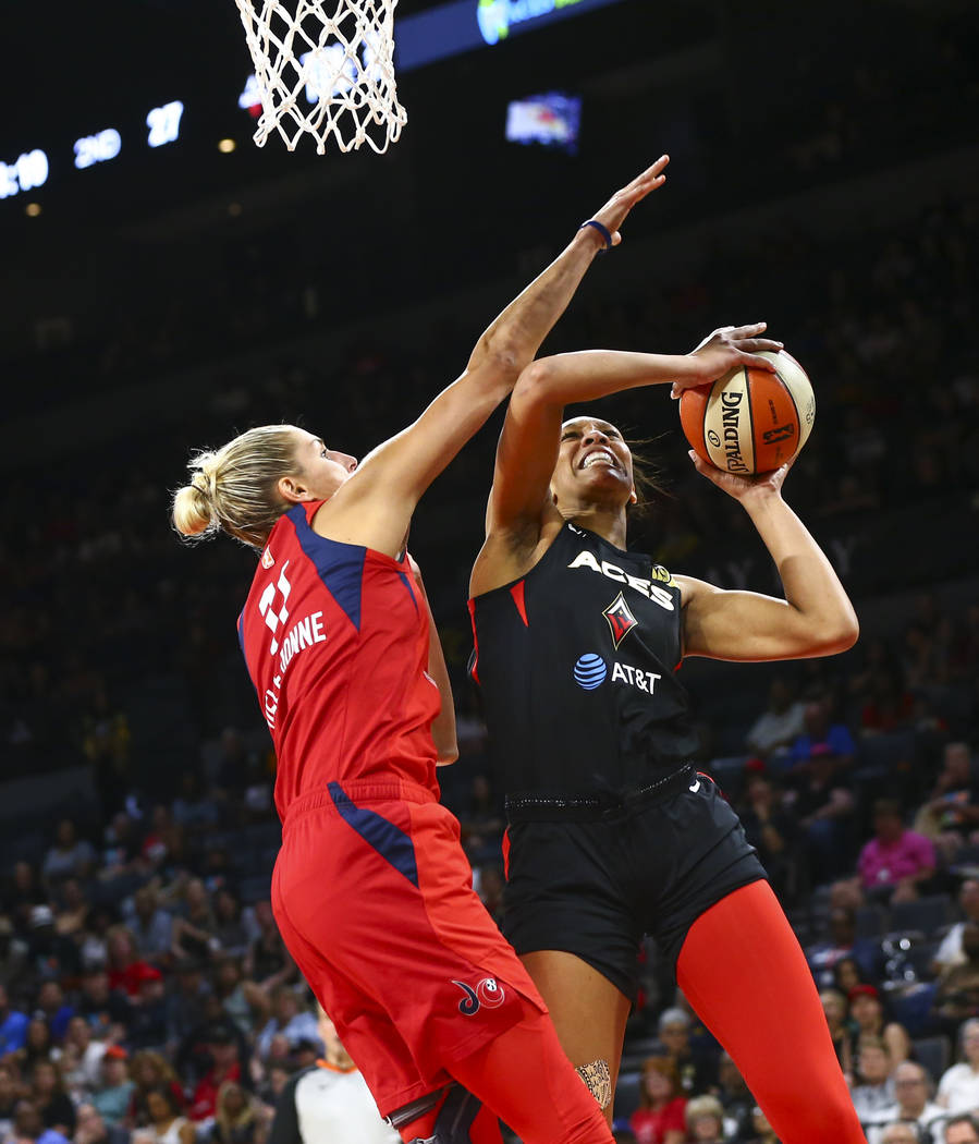 In this June 20, 2019, file photo, Las Vegas Aces center A'ja Wilson, right, goes to the basket ...