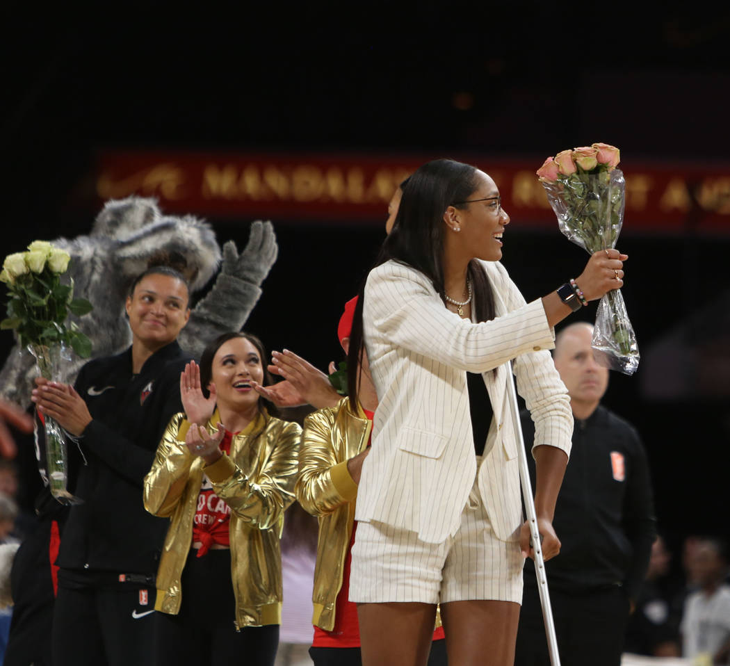 Las Vegas Aces forward A'ja Wilson (22) gets cheered on as she receives flowers for making the ...