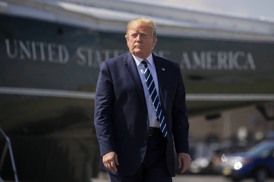 FILE - In this Sunday, July 21, 2019 file photo, President Donald Trump walks on the tarmac to ...