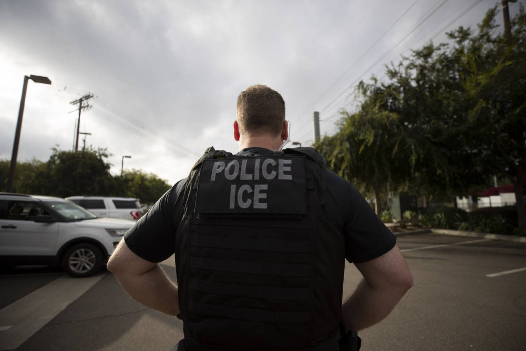 In a July 8, 2019, file photo, a U.S. Immigration and Customs Enforcement (ICE) officer looks o ...